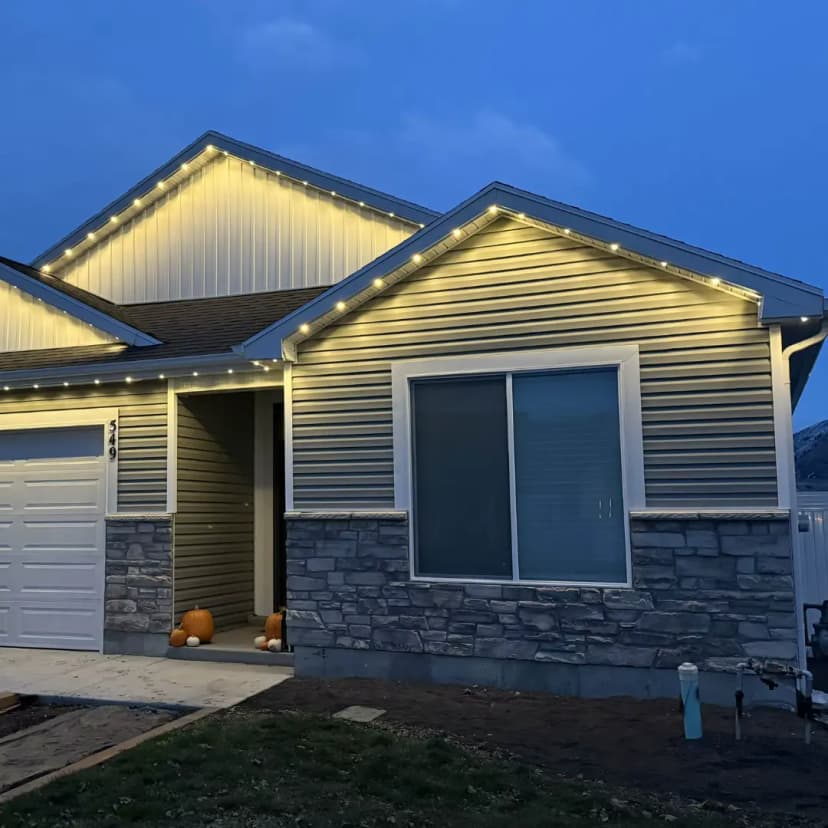 A home lit by warm LED lights from Clear Lighting on Halloween at dusk.