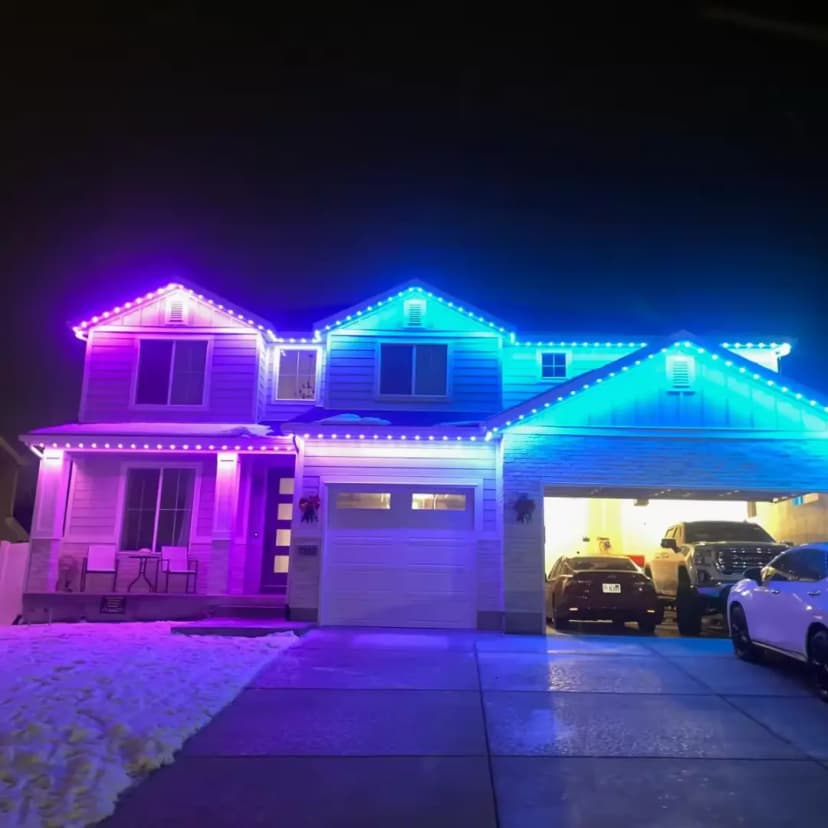 A home lit by purple and blue RGB LED lights from Clear Lighting at night.
